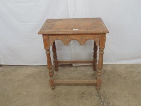 Oak occasional table having carved top and frieze, standing on turned stretchered legs - 24" x 16" x