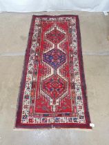 Red ground cream, blue and green patterned runner - 2.22m x 1.016m Please note descriptions are