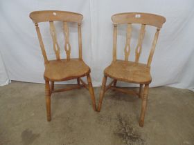 Pair of elm seated country chairs with splat backs and standing on turned stretchered legs Please