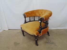 Victorian ebonised button back tub chair with gilt decoration, standing on turned legs to the