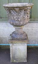 Single 20th century garden urn having decoration of swags of fruit, standing on a square base and