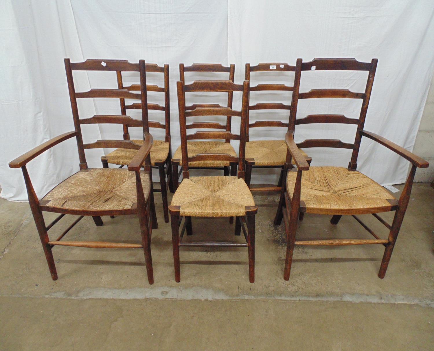 Set of six oak rush seated ladderback country chairs to comprise four chairs and two carvers