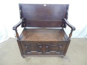 20th century oak monks bench having a rectangular three plank fold over top with single panel seat
