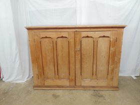 Victorian pine cupboard having two panelled doors opening to reveal three shelves, standing on