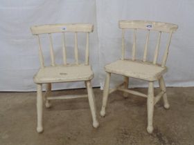 Pair of wooden painted childs chairs with spindle backs and stretchered legs Please note