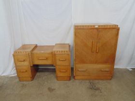 Early 20th century light oak tallboy with two door cupboard enclosing shelf over single drawer,
