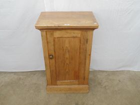 Victorian pine cupboard having single door enclosing three fitted shelves, standing on plinth base -