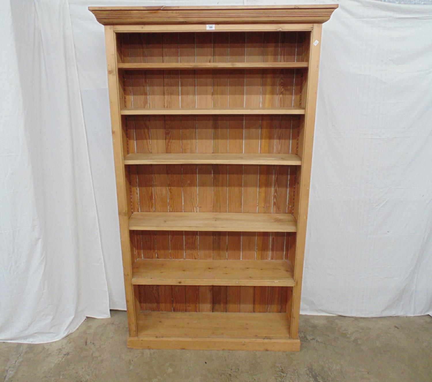 Pine bookcase with one fixed and four adjustable shelves, standing on plinth base - 44.25" x 12.5" x