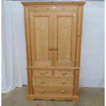 Modern pine two door wardrobe on chest having two short drawers and two long drawers, standing on