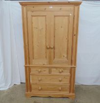 Modern pine two door wardrobe on chest having two short drawers and two long drawers, standing on