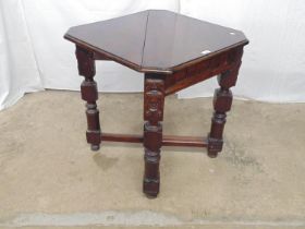 Mahogany carved credence table with cut corners and drop flap over square carved frieze, standing on
