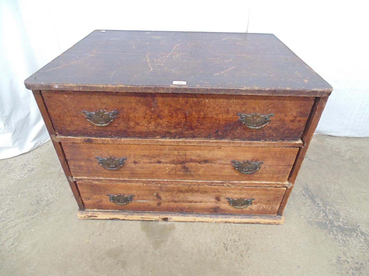 Pine chest of three long drawers having brass handles, standing on plinth base - 35.5" x 26.5" x