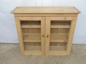 Wall mounted pine cabinet having two glazed door opening to two shelves - 34" x 10.5" x 30.25"