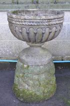 Single garden urn having gadrooned bowl on a circular base, standing on outward tapering plinth -