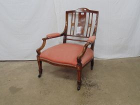 Inlaid mahogany nursing chair with shaped cresting rail, padded arms and serpentine fronted seat,