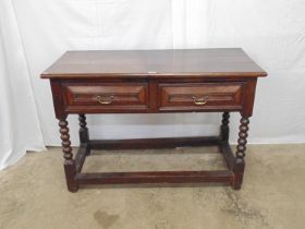 Period oak dresser base having two drawers with brass swan neck handles, standing on bobbin turned