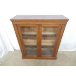 Victorian mahogany two door glazed bookcase opening to two fixed shelves, standing on a plinth