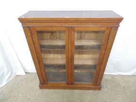 Victorian mahogany two door glazed bookcase opening to two fixed shelves, standing on a plinth