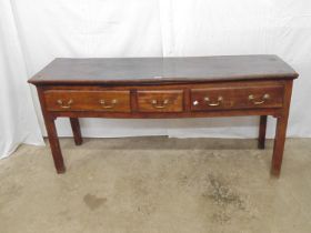 Period oak dresser base having three drawers with brass swan neck handles, standing on square legs -