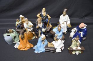 Group of eleven late 20th century pottery figures of Oriental men Please note descriptions are not