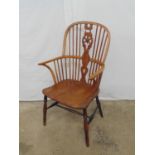 19th century yew wood Windsor chair having spindle and wheelback, standing on turned stretchered