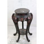 Chinese Ebonised and Red Lacquered Hardwood Stand, carved with flowers and foliage, raised on five
