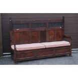 18th century Oak Hall Settle Bench, the triple back with carved upper panels and top rail, carved