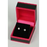 Pair of 14ct white gold diamond stud earrings of 65 points total