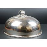 A large silver plated cloche with decorative handle, measures approx 46cm.