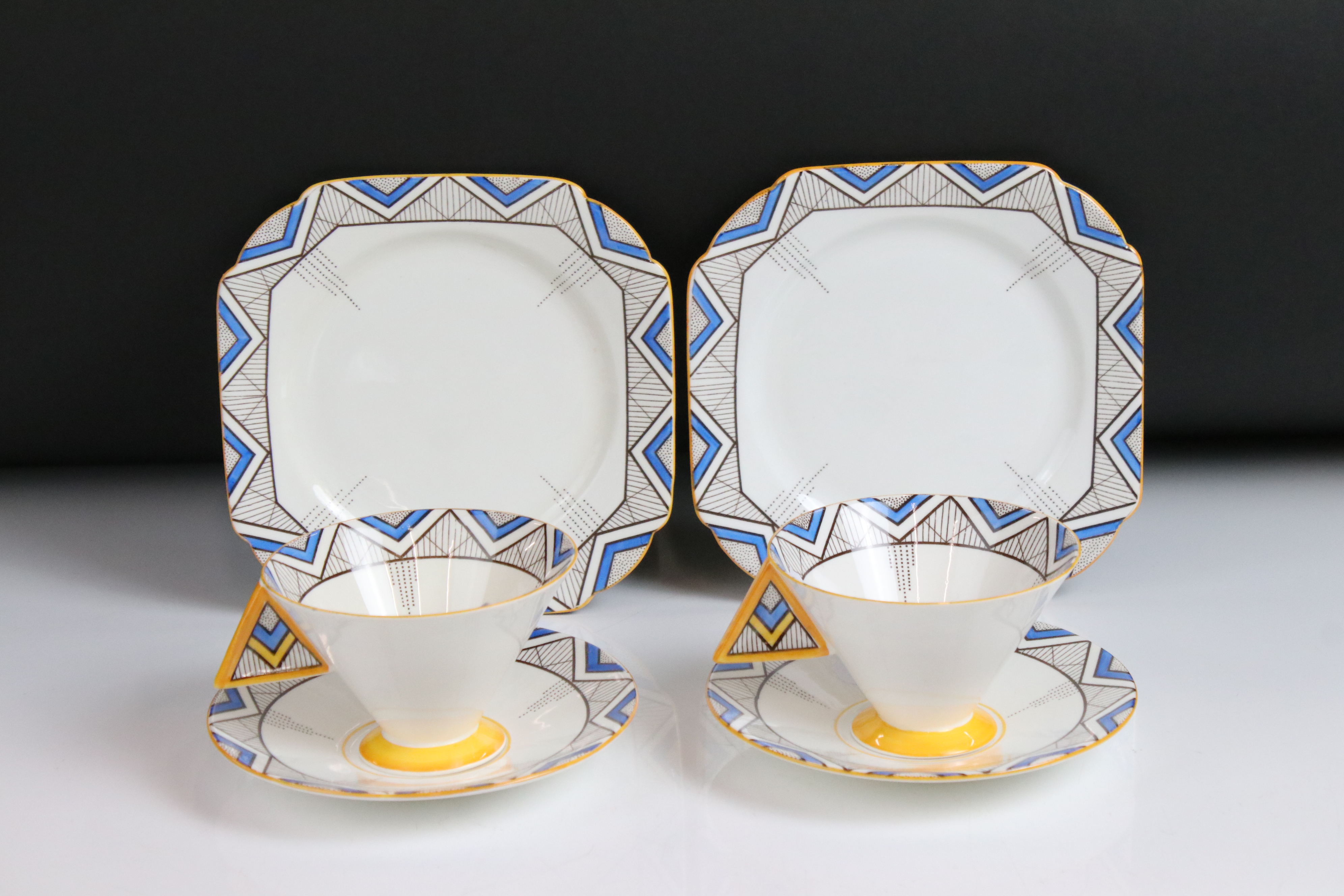 Two Shelley Vogue shaped ' Blue Chevron ' pattern trios comprising 2 teacups, 2 saucers and 2 tea