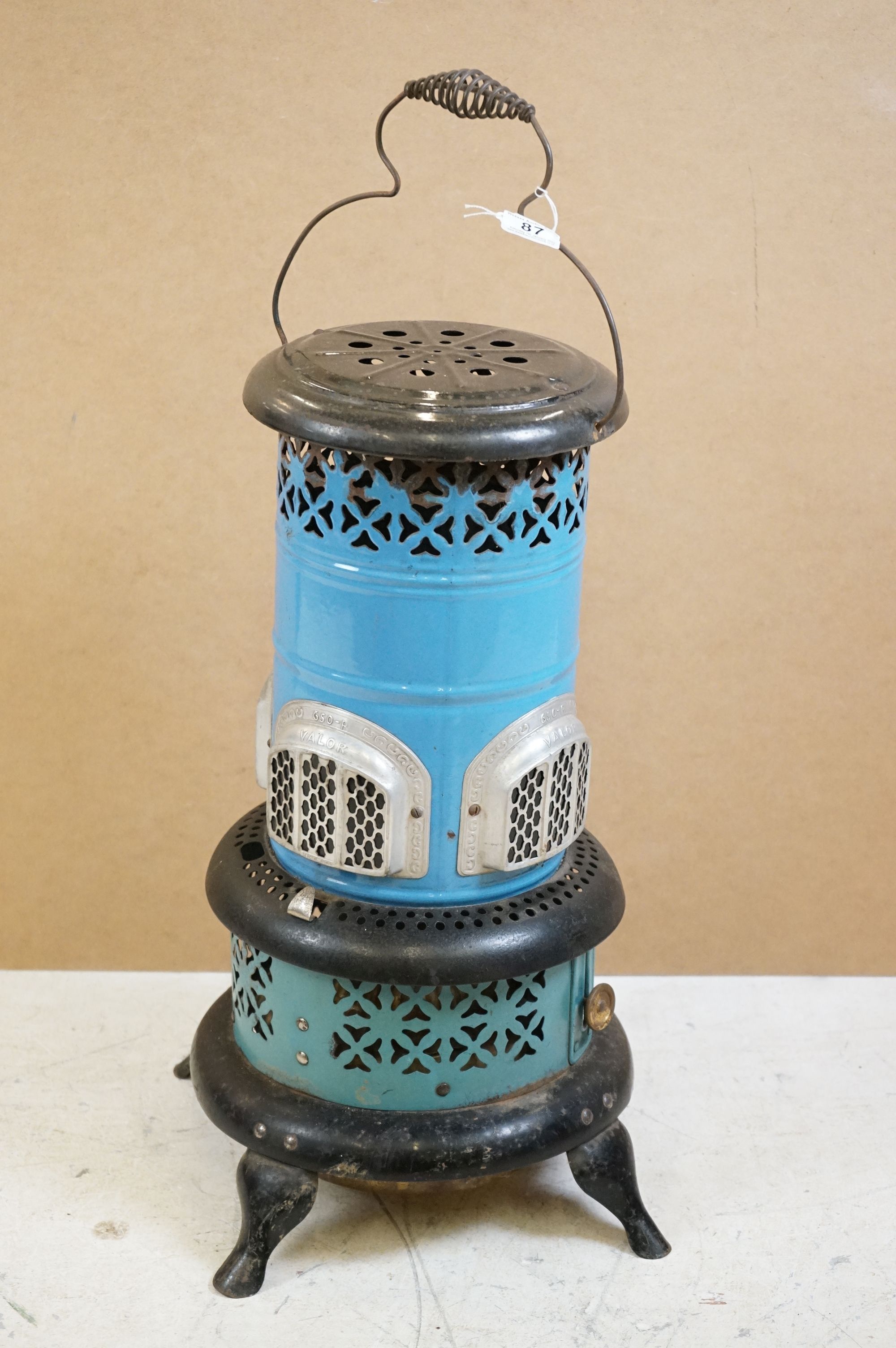 Valor 650-R blue enamel metal paraffin heater of pillar form, raised on four feet, with carry