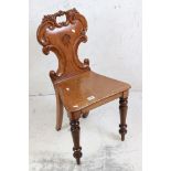 19th century Mahogany Hall Chair with shaped C scroll carved back, raised on turned front legs, 43cm