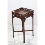 In the manner of Chippendale, Mahogany Kettle Stand with pierced fretwork carving and candle