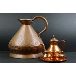 A large antique copper water jug together with a Copper Three Piece Tea Set on Tray