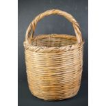 Wicker log basket of cylindrical form, with loop carry handle, approx 53cm high