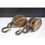 Pair of antique wooden ships pulley blocks with iron hooks and twin cast iron roller wheels, largest