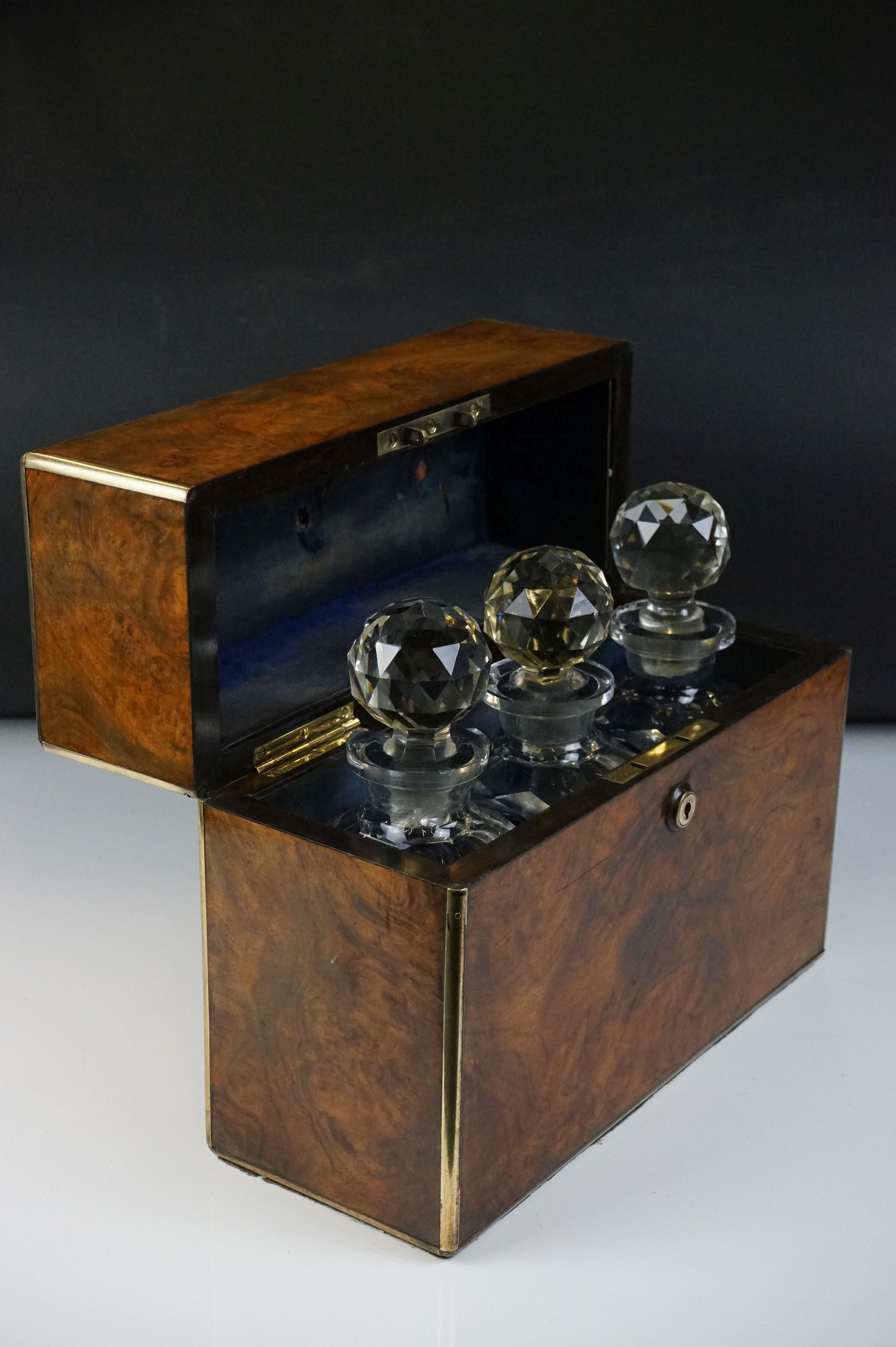 Victorian burr walnut brass-bound three bottle tantalus, containing three matching cut glass - Image 5 of 10