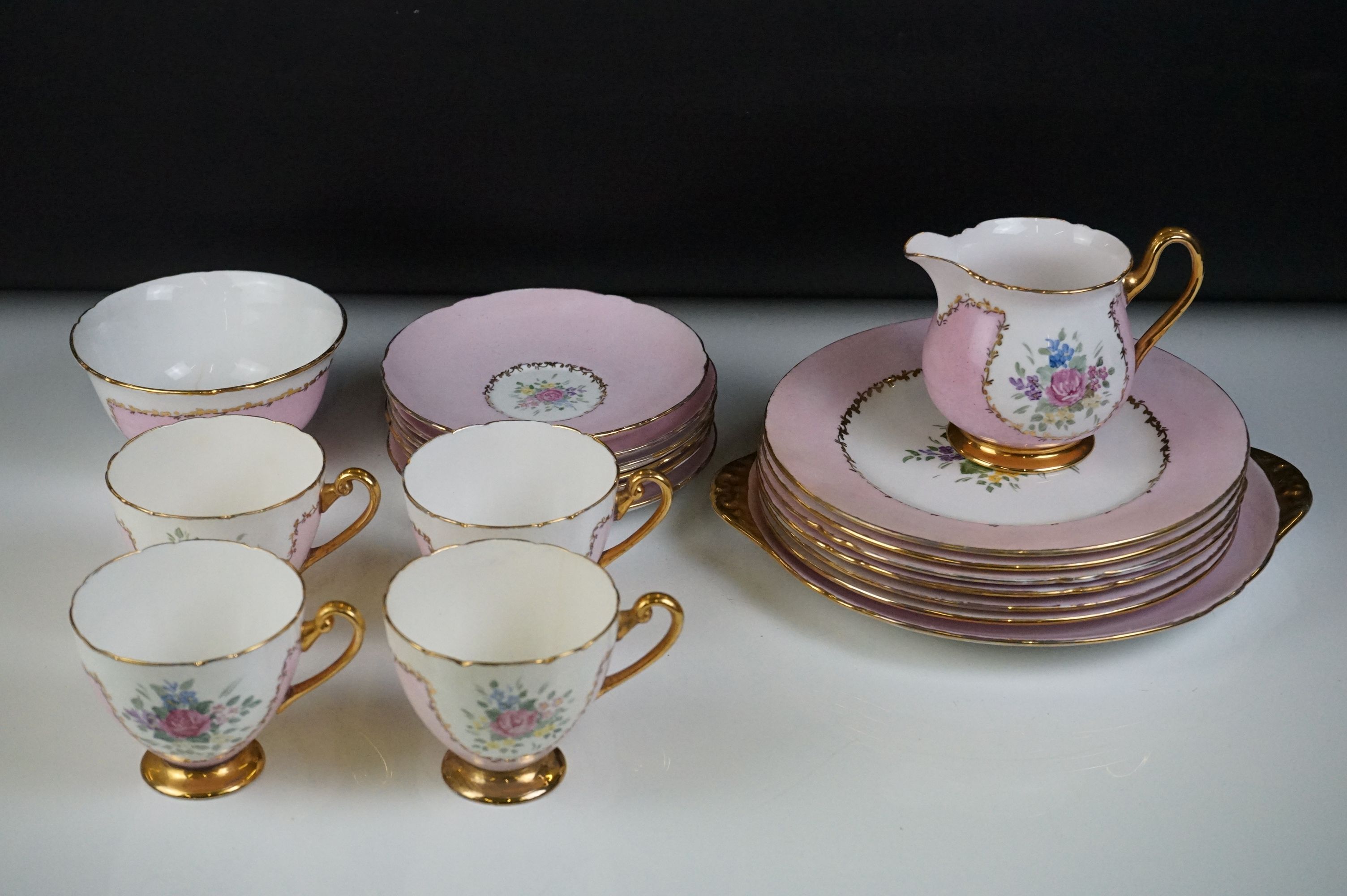 Early 20th Century Shelley hand painted floral tea ware on pink and white ground, with gilt