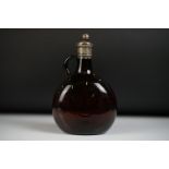 19th Century amber glass spirit flask with white metal mount & stopper, the glass body of bulbous