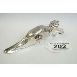 A large white metal paperclip in the form of a ducks head.