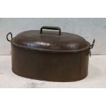 Large twin-handled steel cooking pot & cover, of oval form, with interior drainer, 67cm long