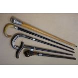 Five antique walking sticks to include a bamboo walking stick with engine turned silver hallmarked