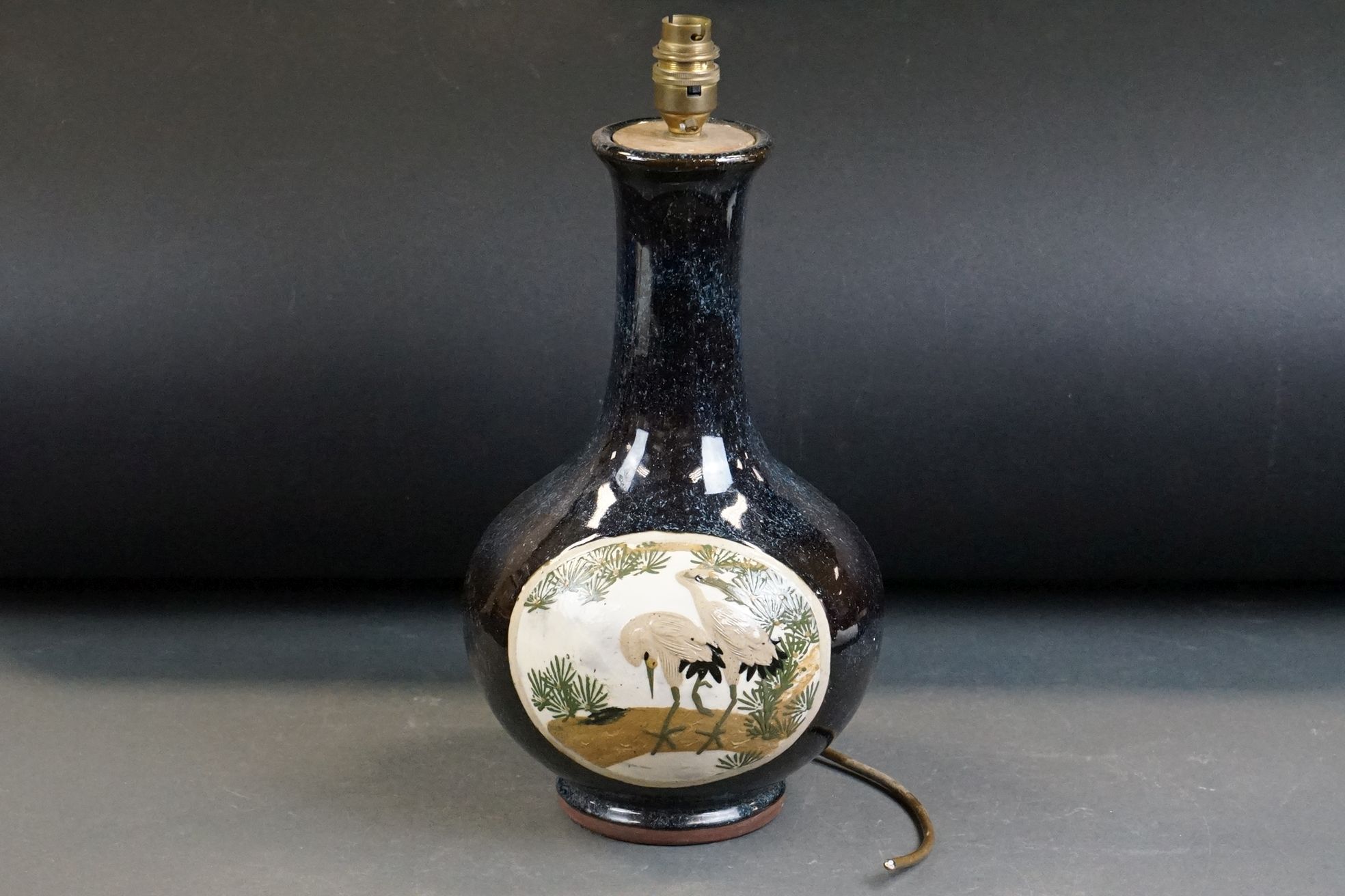 20th Century Pottery bottle vase with relief moulded stork panel decoration on a mottled blue
