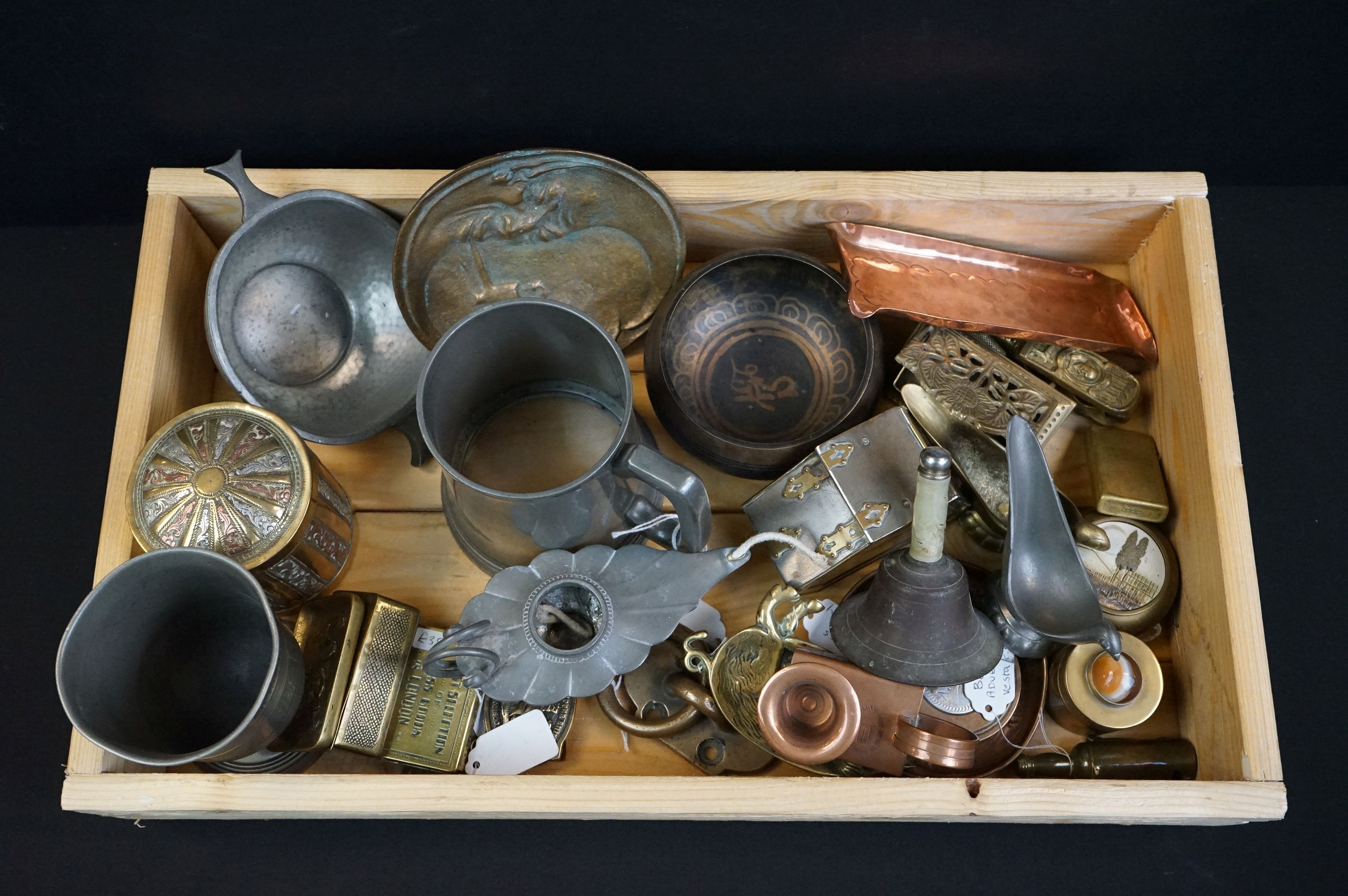 A small collection of mixed metal ware to include a pewter quaich, brass stamp holder, brass zippo