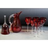 Whitefriars ruby red water jug with clear glass ribbed handle, 20cm high, together with a set of