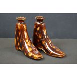 A pair of antique treacle glaze spirit flask bottles in the form of boots.