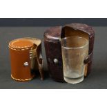 An antique glass medicine cup in leather travel case together with a cased set of four stirrup cups.