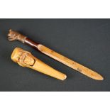 A treen letter opener with pug dog finial together with figural nut cracker.