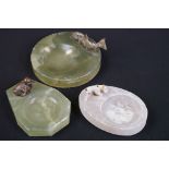 A collection of three carved stone ashtray's adorned with animal figures to include duck, fish and a