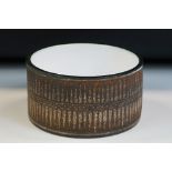 Troika pottery drum bowl, of circular form with geometric sawtooth-like design to border on brown